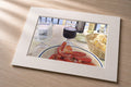 Lunch in France – matted fine art print of a French table with tomatoes, wine, and bread in oil by Patti Vrabel